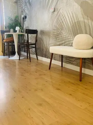 a room with a wooden floor and a chair and a table at ZAIRA ROMA HOUSE, alloggio per uso turistico in Rome