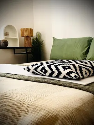 a bed with a black and white blanket on it at ZAIRA ROMA HOUSE, alloggio per uso turistico in Rome