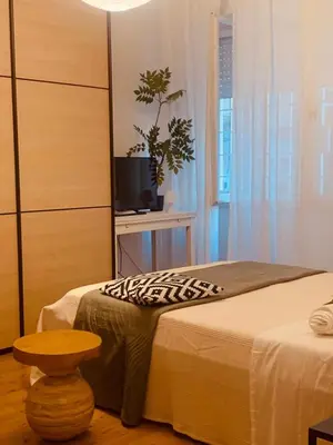 a bedroom with a bed and a tv and a table at ZAIRA ROMA HOUSE, alloggio per uso turistico in Rome