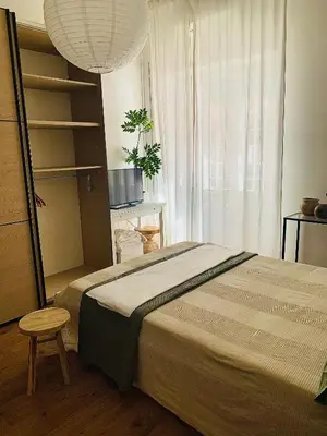 a bedroom with a bed and a chair and a window at ZAIRA ROMA HOUSE, alloggio per uso turistico in Rome