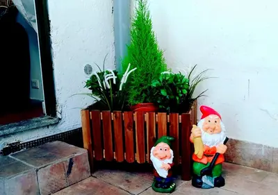 two santa claus figurines sitting next to a plant at RHOMENJOY Pied-à-terre Colosseo in Rome