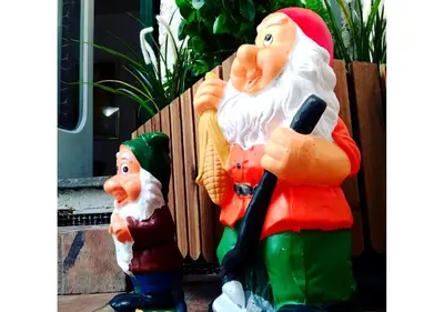 two santa claus statues sitting on a porch at RHOMENJOY Pied-à-terre Colosseo in Rome