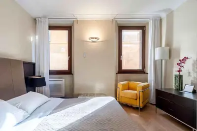 a bedroom with a bed and a yellow chair at Charming in Rome
