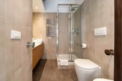 a bathroom with a shower and a white toilet at Charming in Rome