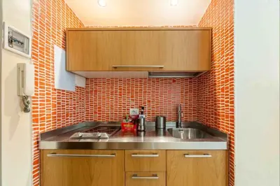 a kitchen with a sink and a brick wall at Charming in Rome