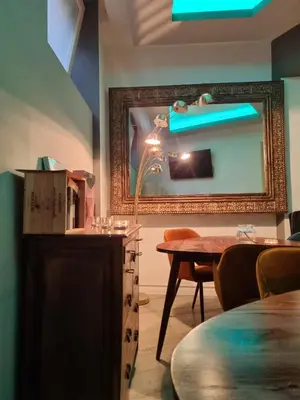 a room with a table and a mirror at Corso Boutique Luxury Rooms in Rome