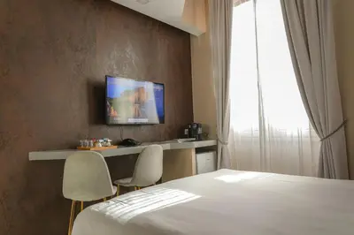 a hotel room with a bed and two chairs at Corso Boutique Luxury Rooms in Rome