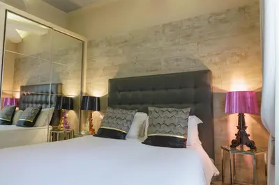 a bedroom with a large bed with a large mirror at Corso Boutique Luxury Rooms in Rome