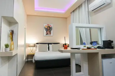 a bedroom with a bed and a desk with a mirror at Corso Boutique Luxury Rooms in Rome