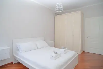a white bedroom with a white bed with two towels on it at Stile e spazio nel cuore di Roma in Rome