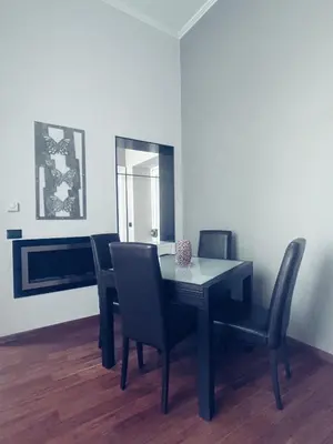 a dining room with a black table and chairs at La Dimora del Brancaccio in Rome