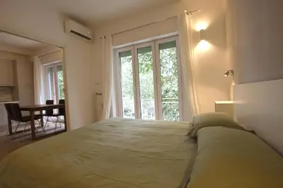 a bedroom with a bed and a large window at Inventori Tevere Suite in Rome