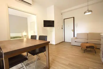 a living room with a table and a couch at Inventori Tevere Suite in Rome