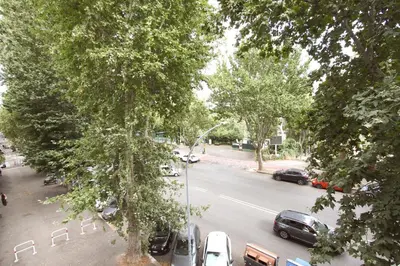 a street with cars parked on the side of the road at Inventori Tevere Suite in Rome