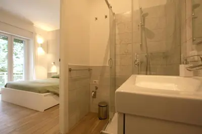 a bathroom with a tub and a sink and a shower at Inventori Tevere Suite in Rome