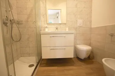 a bathroom with a shower and a sink and a toilet at Inventori Tevere Suite in Rome