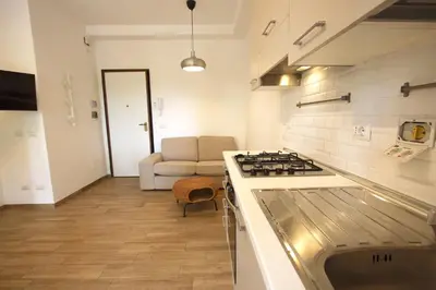 a kitchen with a stove top oven next to a couch at Inventori Tevere Suite in Rome
