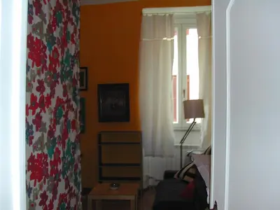 a living room with a window and a curtain at Appartamento del Boschetto in Rome