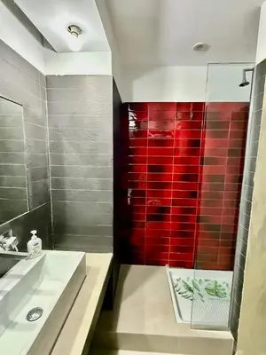 a bathroom with a sink and a red wall at Luna Guest House in Rome