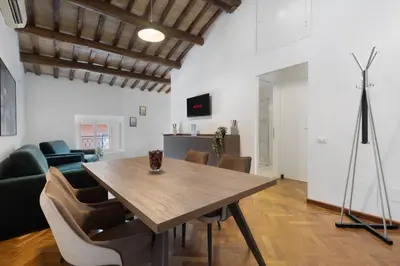 a dining room with a wooden table and chairs at Appartamento Campo Marzio Lusso in Rome