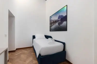 a bedroom with a bed and a picture on the wall at Appartamento Campo Marzio Lusso in Rome