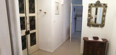 a hallway with a mirror on the wall and a table at Hanna's House Metro Pyramid in Rome
