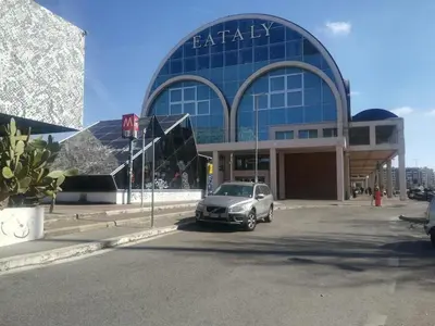 a car parked in front of a large building at Hanna's House Metro Pyramid in Rome