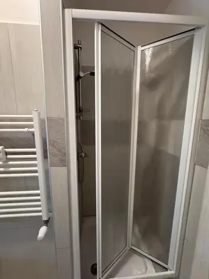 a shower stall with a glass door in a bathroom at Hanna's House Metro Pyramid in Rome