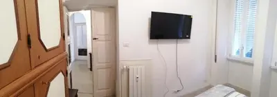 a television hanging on a wall in a room at Hanna's House Metro Pyramid in Rome