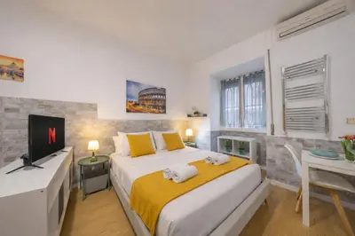 a bedroom with a bed and a desk and a tv at Open Space Moderno a 20 Minuti dal Colosseo vicino alla Metro A e C in Rome