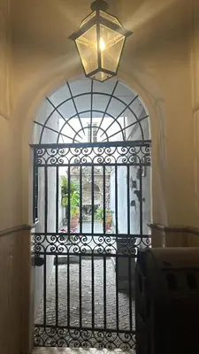 an iron gate with a window and a chandelier at Colosseo Promenade in Rome