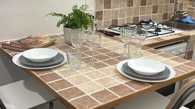 a table with plates and glasses on a kitchen counter at Colosseo Promenade in Rome