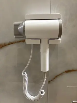 a phone hanging on a wall in a bathroom at Gianvenuti House Rome - Metro A with Jacuzzi in Rome