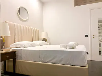 a bedroom with a white bed with towels on it at Beautiful apartment within walking distance of the Vatican in Rome