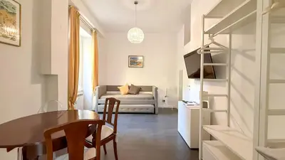 a living room with a table and a couch at Beautiful apartment within walking distance of the Vatican in Rome