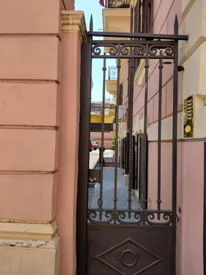 a black door on a building with a street at Karma Trastevere Loft in Rome