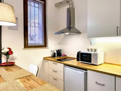 a kitchen with a counter top with a microwave at Karma Trastevere Loft in Rome