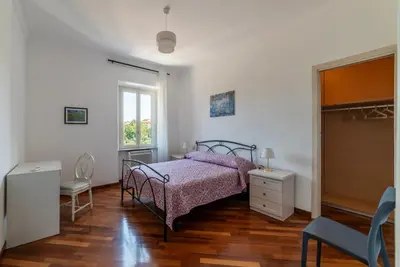 a bedroom with a bed and a dresser and a window at GuestHost - Bright Apartment in Metro San Giovanni in Rome