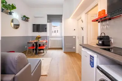 a kitchen and living room with a table and chairs at ht vittorio in Rome