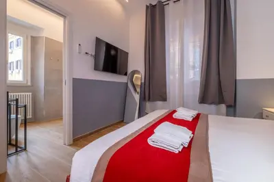 a bedroom with a bed with a red blanket at ht vittorio in Rome