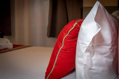 a red and white dress sitting on top of a bed at ht vittorio in Rome