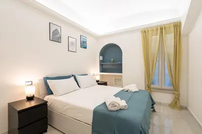 a small bedroom with a bed and a window at lollo's home in Rome