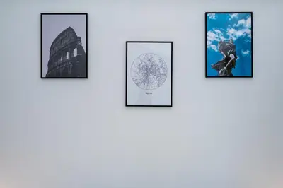 a group of four framed photographs of the wonders of the world at lollo's home in Rome