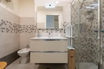 a bathroom with a sink and a toilet and a shower at lollo's home in Rome