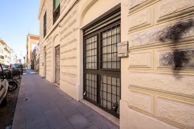 a building with a door on the side of a street at lollo's home in Rome