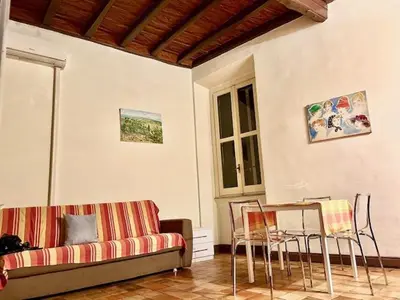 a living room with a couch and a table and chairs at The Father s House in Rome