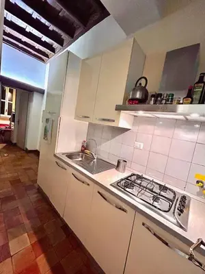 a white kitchen with a sink and a stove at The Father s House in Rome