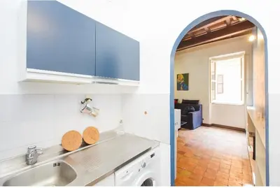 a kitchen with a sink and an archway over a counter at The Father s House in Rome