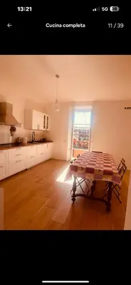a kitchen with white cabinets and a stove top oven at Interno 12 in Rome