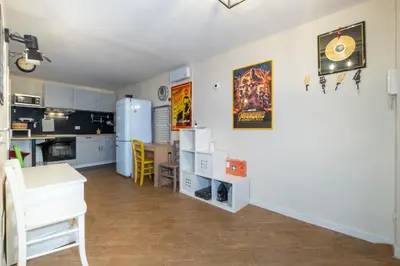 a kitchen and dining room with a refrigerator at ht movie flat bilo in Rome